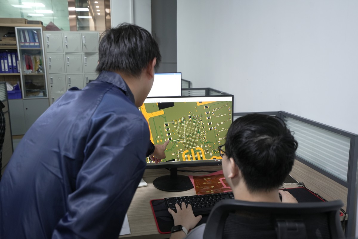 EBest PCBA production team member reviewing SMT process information