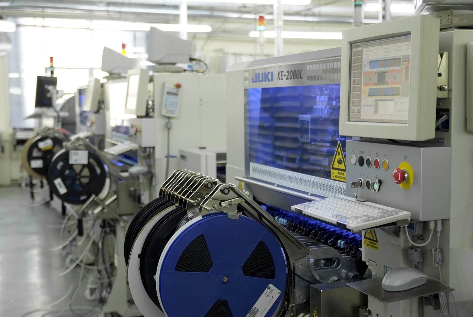 SMT production equipment operating in an electronics manufacturing line