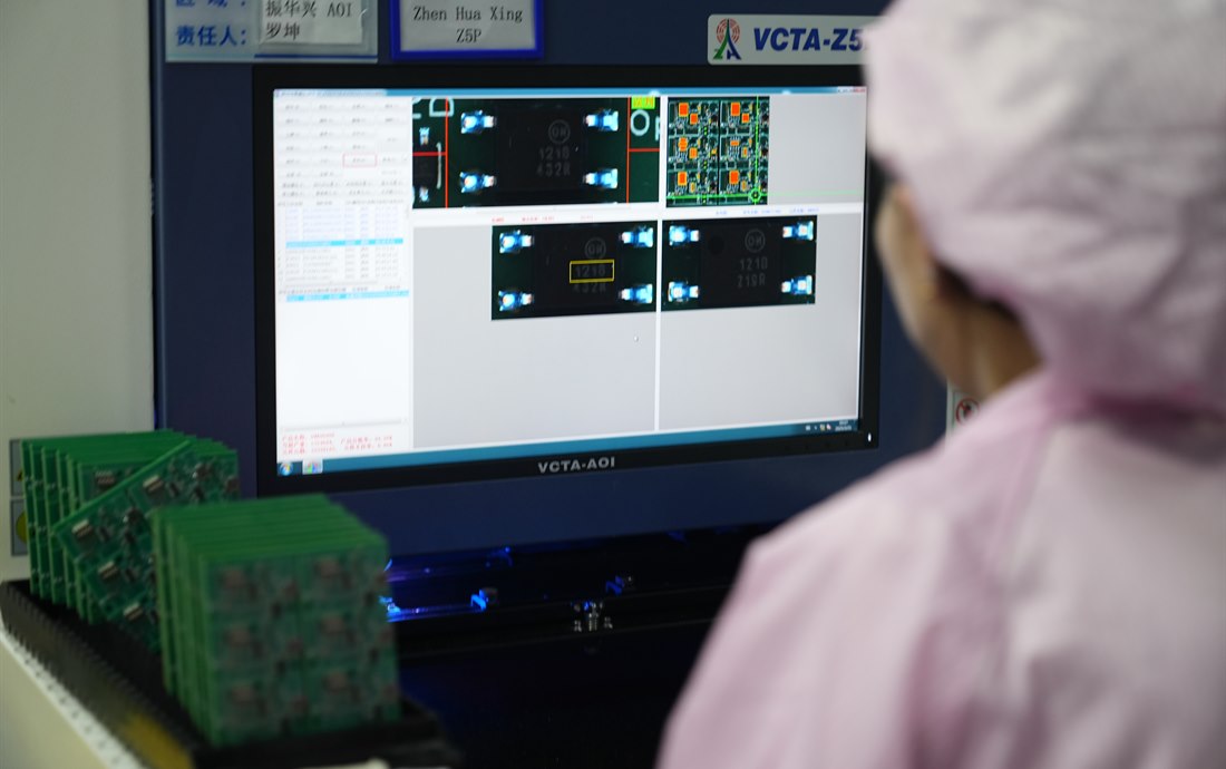 Operator reviewing PCBA AOI inspection results
